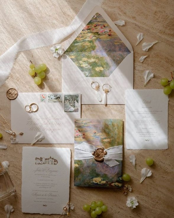 A wedding stationery suite with envelope, wax seal and rings
